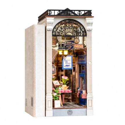 Book Nook Kit Arcade Dating DIY Kit with ornate white arch, warm lamps, flowers, signs, and miniature storefront