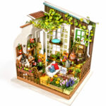 Book Nook Kit Miller's Garden miniature with vines, flowers, seating and gardening accessories on white