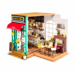 Book Nook Kit Simon's Coffee miniature café with red awning, counter, tables, chairs and piano on white